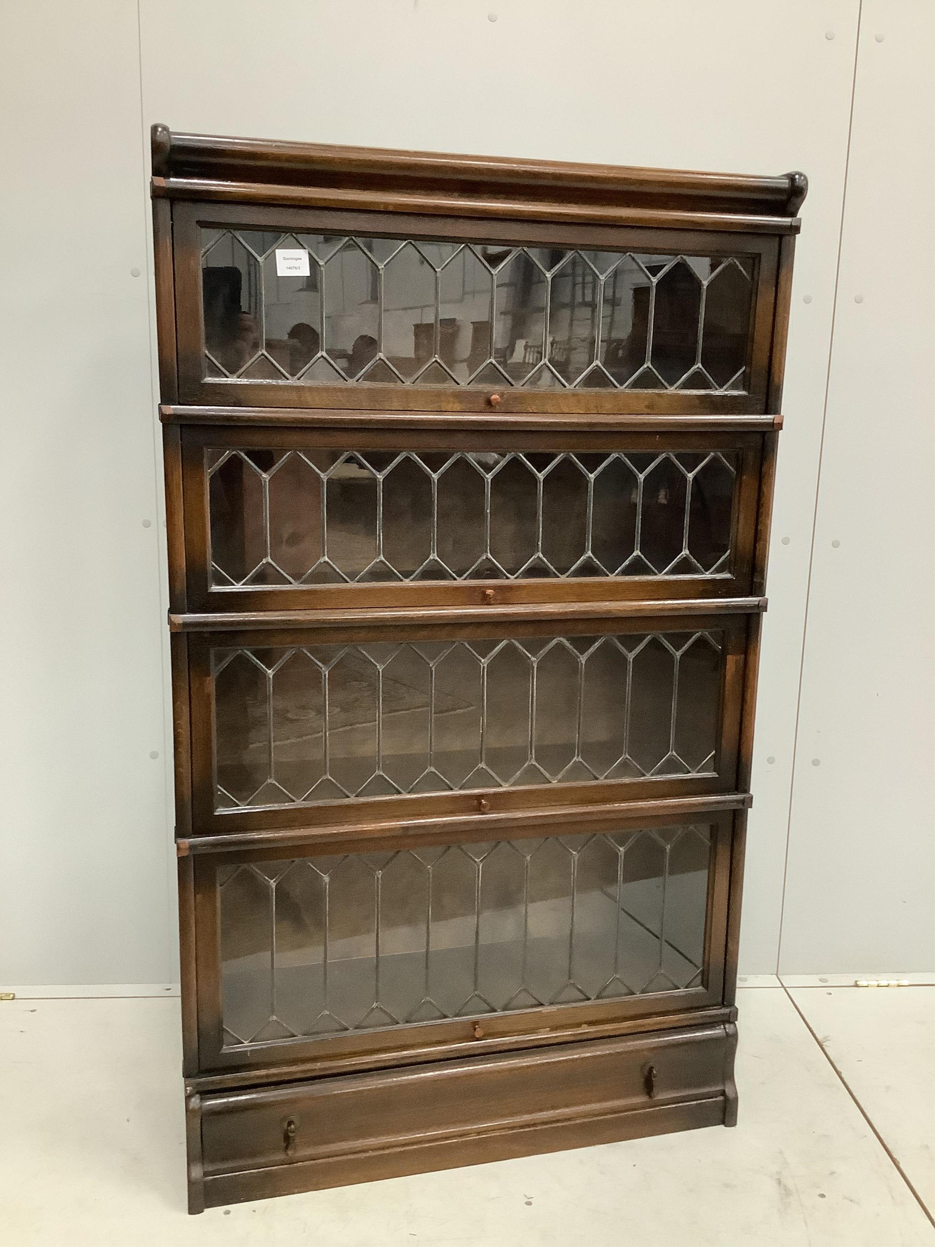 A Globe Wernicke oak four section bookcase with leaded glazed doors, width 86cm, depth 30cm, height 146cm